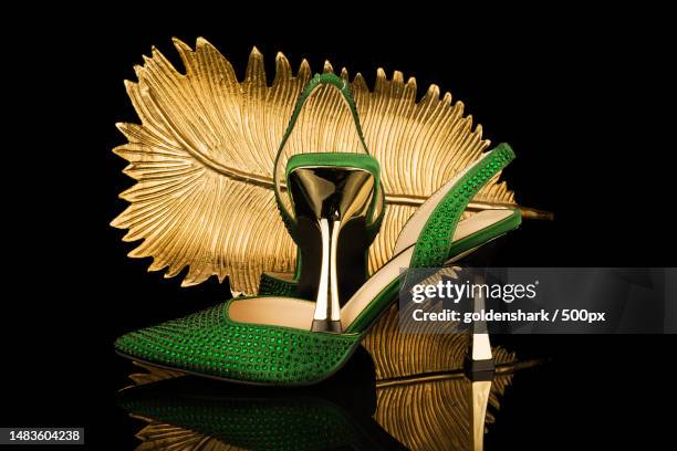 sexy,high heel shoes on black and gold background,united kingdom,uk - editorial image stock pictures, royalty-free photos & images