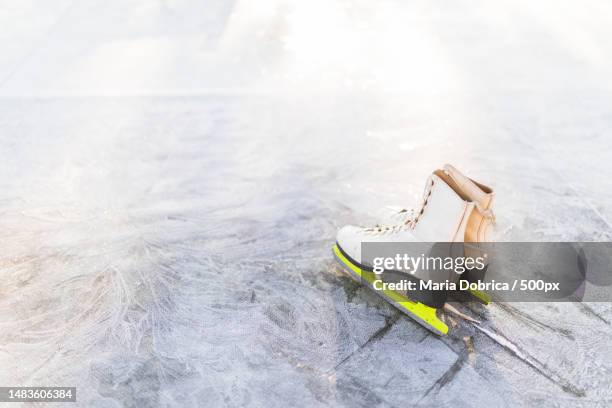 high angle view of ice skates on ice rink,romania - ice skate close up stock pictures, royalty-free photos & images