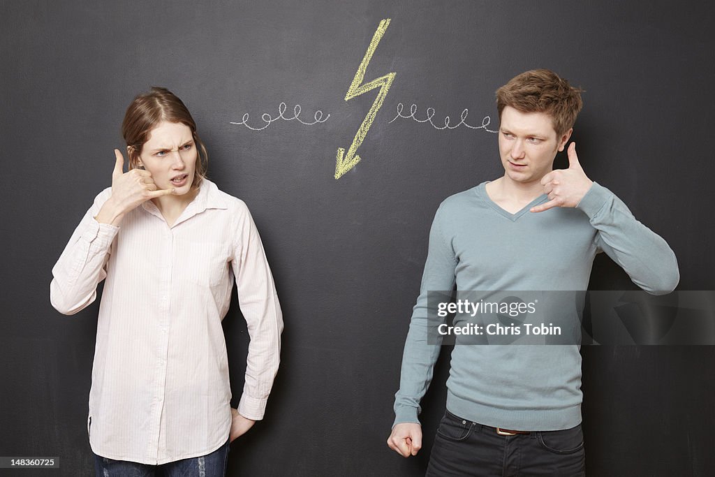 Young man and woman fighting on the phone