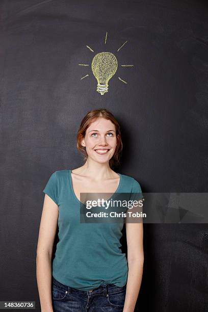 girl with idea light bulb - smart stock-fotos und bilder