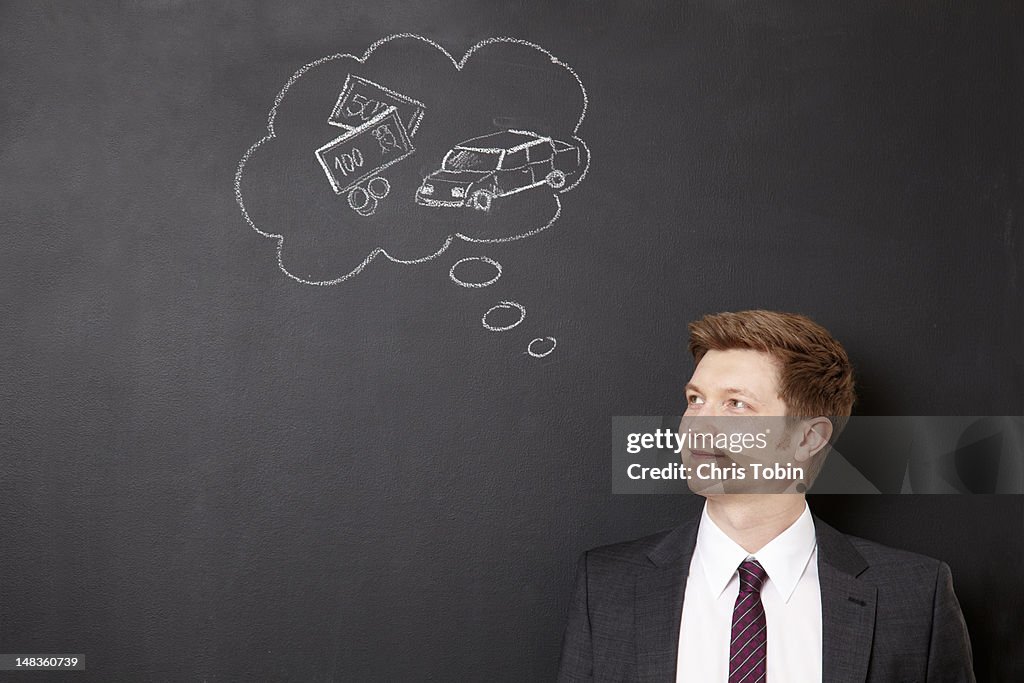 Man dreaming of money and cars