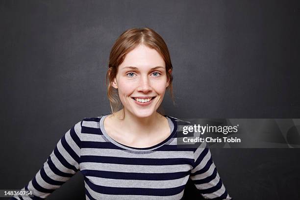 young woman smiling - blonde hair black background stock pictures, royalty-free photos & images