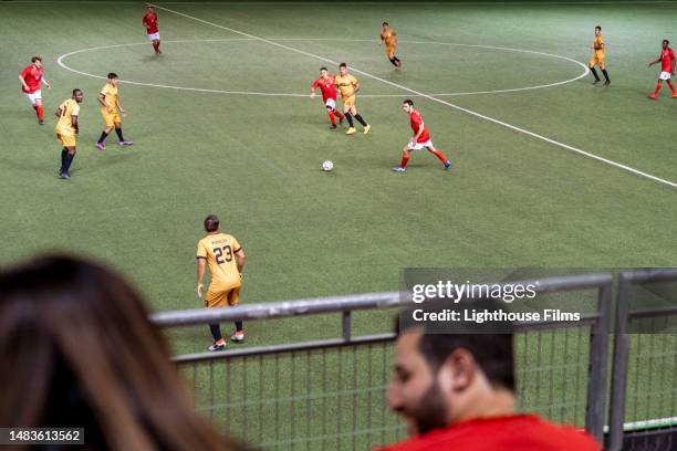 spectators sit on bleachers watching international soccer match in stadium - partido rondas deportivas fotografías e imágenes de stock