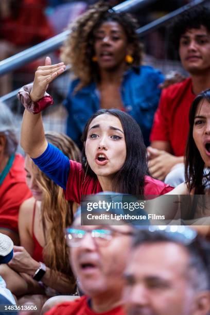 female soccer fan passionately yells and makes frustrated gesture in bleachers - soccer huddle stock pictures, royalty-free photos & images