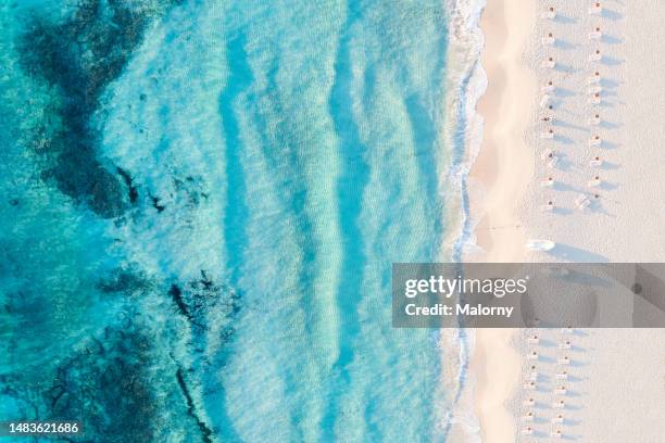 aerial view of the sea and a beach with beach chairs lined up. - lounge chair stock pictures, royalty-free photos & images