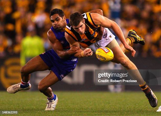 Nathan Djerrkura of the Bulldogs contests the ball with Ben Stratton of the Hawks during the round 16 AFL match between the Western Bulldogs and the...