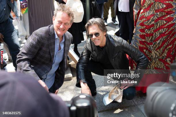 Michael Bacon and Kevin Bacon pose by their plaque at the 2023 Philadelphia Music Alliance Walk Of Fame Plaque Unveilings outside of University of...