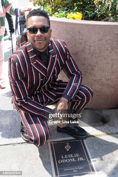 Leslie Odom Jr. Poses by his plaque during the 2023 Philadelphia Music Alliance Walk Of Fame Plaque Unveilings outside of University of the Arts on...