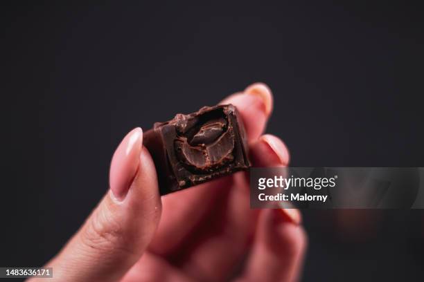 chocolate praline on black background. - milk chocolate truffles stock pictures, royalty-free photos & images