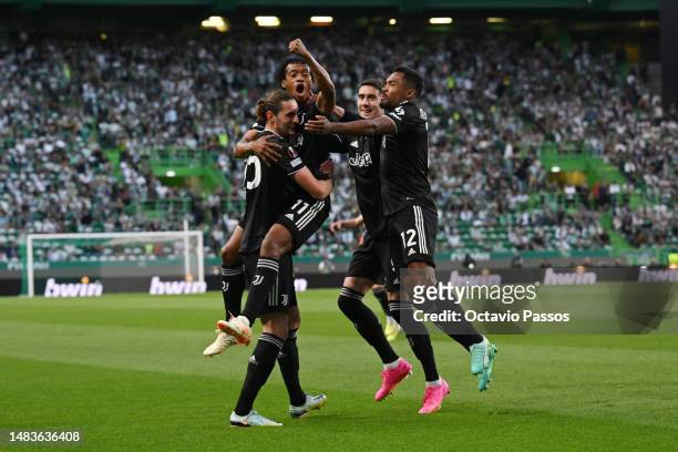 Adrien Rabiot of Juventus celebrates with Juan Cuadrado and team mates after scoring the team's first goal during the UEFA Europa League Quarterfinal...