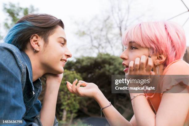 couple lesbian woman with gay pride flag on the street - social awareness symbol stock pictures, royalty-free photos & images