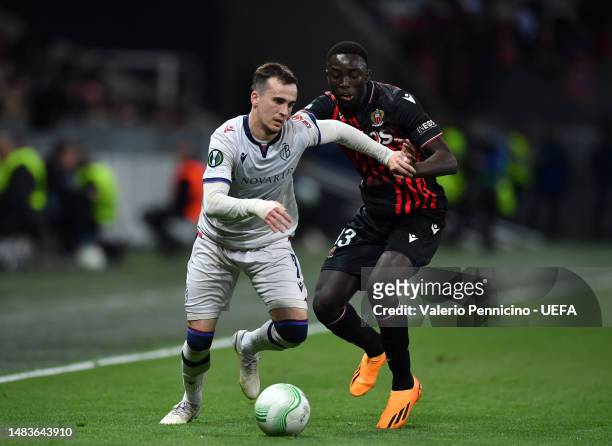Liam Millar of FC Basel runs with the ball whilst under pressure from Antoine Mendy of OGC Nice during the UEFA Europa Conference League Quarterfinal...