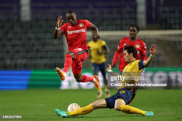 Koki Machida of Royale Union Saint-Gilloise tackles Moussa Diaby of Bayer 04 Leverkusen during the UEFA Europa League Quarterfinal Second Leg match...