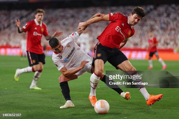 Harry Maguire of Manchester United is challenged by Erik Lamela of Sevilla FC during the UEFA Europa League Quarterfinal Second Leg match between...