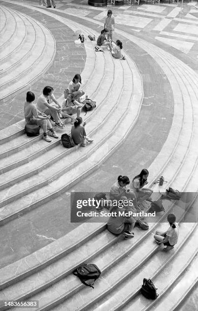 Elevated view of people sitting on the steps of the Winter Garden Atrium at the World Trade Center complex, New York, New York, July 4, 1997.