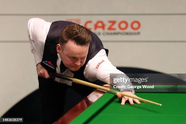 Shaun Murphy of England plays a shot during their round one match against Si Jiahui of China on Day Six of the Cazoo World Snooker Championship 2023...