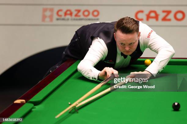 Shaun Murphy of England plays a shot during their round one match against Si Jiahui of China on Day Six of the Cazoo World Snooker Championship 2023...