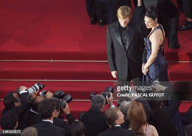 French actor Benoit Magimel and his partner Nikita Lespinasse pose for photographers as they arrive for the screening of Austrian director Michael...