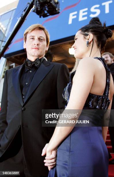 French actor Benoit Magimel and his partner Nikita Lespinasse pose for photographers as they arrive for the screening of Austrian director Michael...