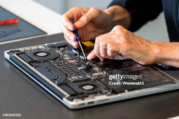 man repairing laptop with screwdriver - disassembled stock pictures, royalty-free photos & images