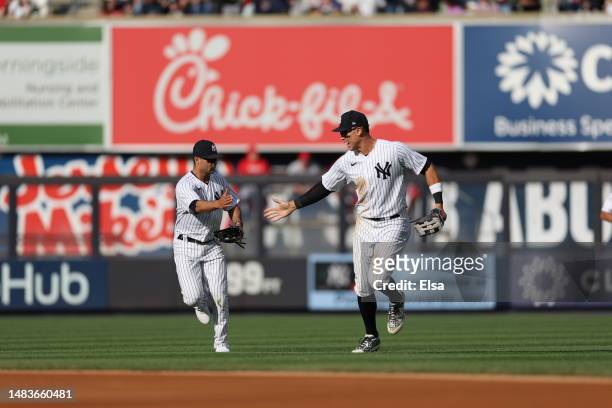Isiah Kiner-Falefa of the New York Yankees is congratulated by teammate Aaron Judge after Kiner-Falefa caught a hit from Renfroe of the Los Angeles...