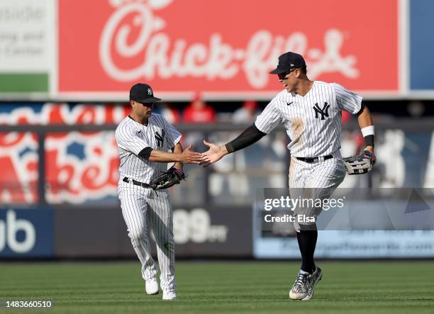 Isiah Kiner-Falefa of the New York Yankees is congratulated by teammate Aaron Judge after Kiner-Falefa caught a hit from Renfroe of the Los Angeles...