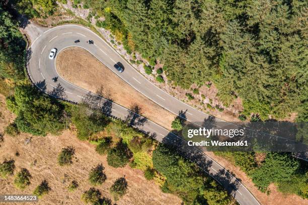 germany, baden-wurttemberg, aerial view of hairpin curve of asphalt road in black forest - hairpin curve stock pictures, royalty-free photos & images