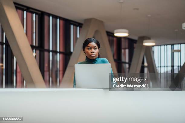thoughtful businesswoman with laptop by railing - student behind laptop stock pictures, royalty-free photos & images