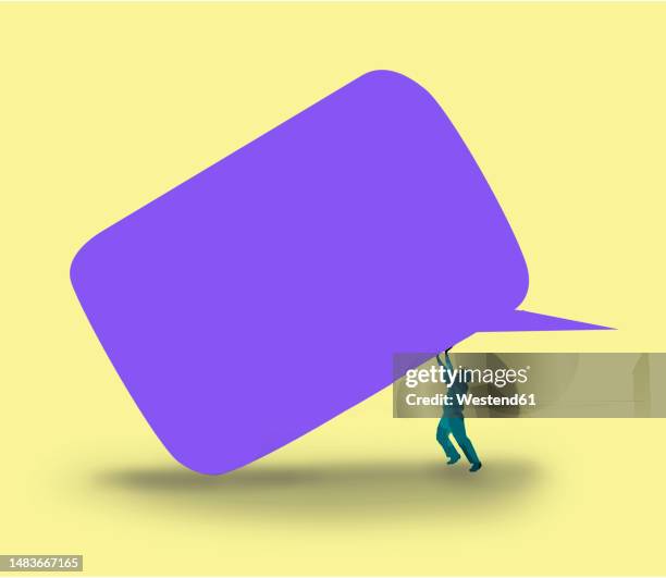 man pushing large blank speech bubble - speech bubbles stock illustrations