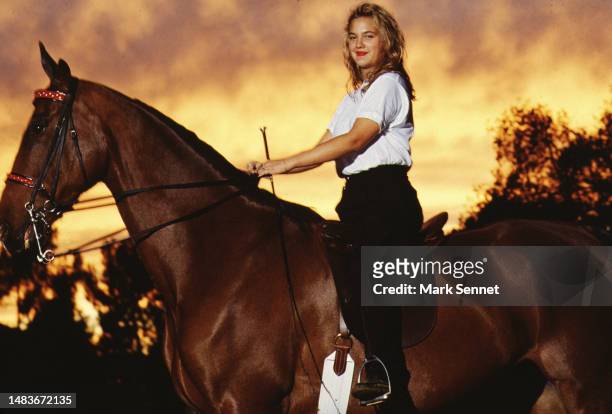Actress Drew Barrymore poses riding a horse for People Magazine in 1990 in Los Angeles