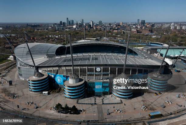 An aerial view of the Etihad Stadium, home of Manchester City, with the Manchester skyline behind on April 20, 2023 in Manchester, United Kingdom.