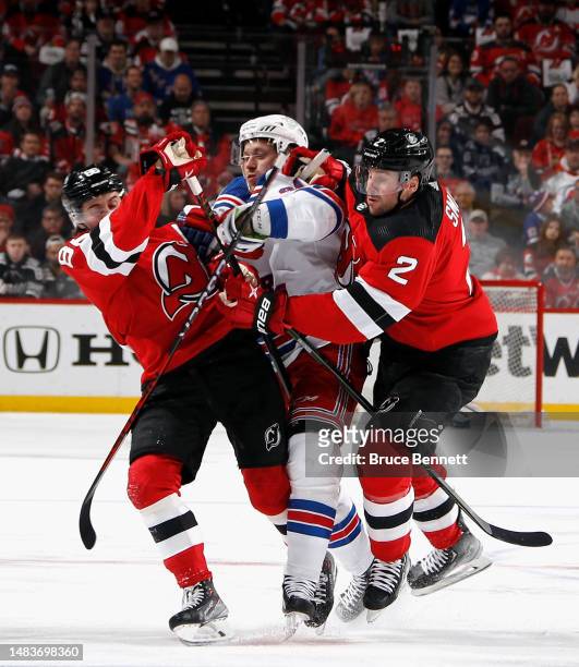 Jack Hughes and Brendan Smith of the New Jersey Devils combine to check Vladimir Tarasenko of the New York Rangers during the first period during...