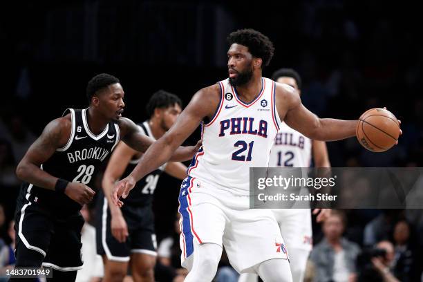 Joel Embiid of the Philadelphia 76ers dribbles against Dorian Finney-Smith of the Brooklyn Nets during the first half of Game Three of the Eastern...