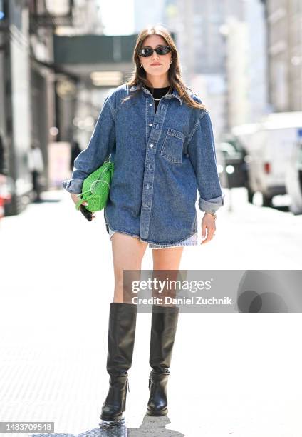 Nowee Nuyens is seen wearing a black top, denim Cos shirt, vintage green bag and black boots on April 20, 2023 in New York City.