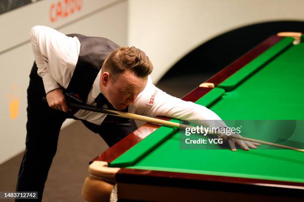 Shaun Murphy of England plays a shot in the first round match against Si Jiahui of China on day 6 of the 2023 Cazoo World Championship at Crucible...