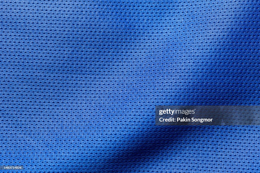 Blue color sports clothing fabric football shirt jersey texture and textile background.