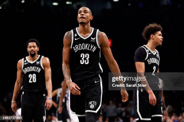 Spencer Dinwiddie, Nic Claxton, and Cameron Johnson of the Brooklyn Nets react against the Philadelphia 76ers during the second half of Game Three of...