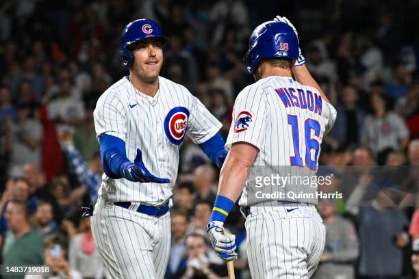 Cody Bellinger and Patrick Wisdom of the Chicago Cubs celebrate after the home run in the second inning against the Los Angeles Dodgers at Wrigley...