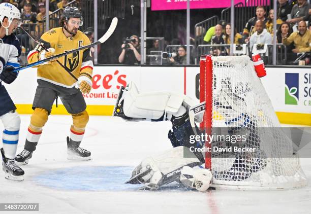 Connor Hellebuyck of the Winnipeg Jets makes a save during the first period against the Vegas Golden Knights in Game Two of the First Round of the...