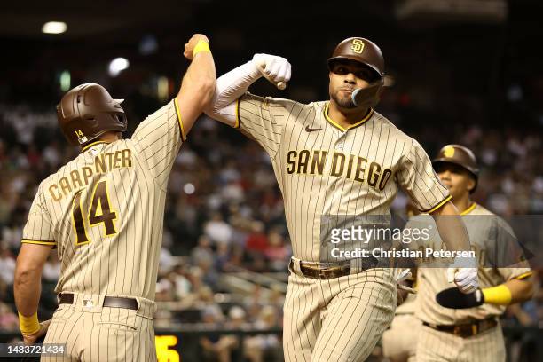 Xander Bogaerts of the San Diego Padres celebrates with Matt Carpenter after hitting a two-run home run against the Arizona Diamondbacks during the...