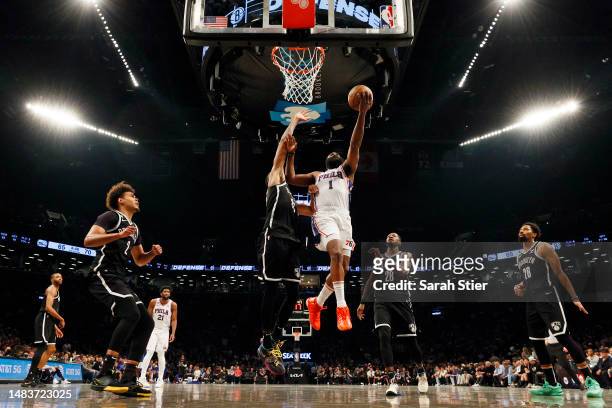 James Harden of the Philadelphia 76ers goes to the basket as Nic Claxton of the Brooklyn Nets defends during the second half of Game Three of the...