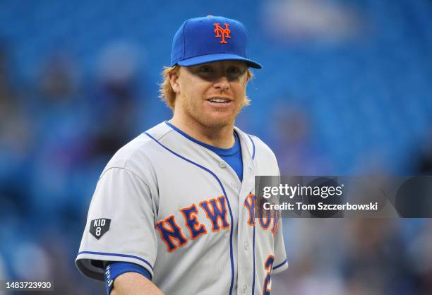 Justin Turner of the New York Mets looks on from first base as he wears a patch on his sleeve commemorating the death of former player Gary Carter...