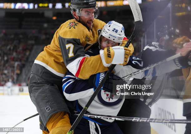 Alex Pietrangelo of the Vegas Golden Knights jumps on the back of Blake Wheeler of the Winnipeg Jets during the first period in Game Two of the First...