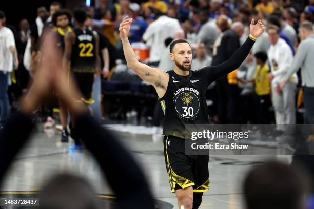 Stephen Curry of the Golden State Warriors reacts after he made a basket at the end of the first half against the Sacramento Kings during Game Three...