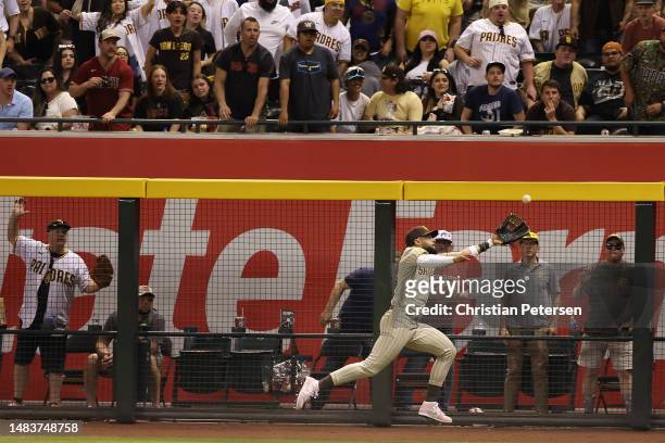 Outfielder Fernando Tatis Jr. #23 of the San Diego Padres makes a running catch during the eighth inning of the MLB game against the Arizona...