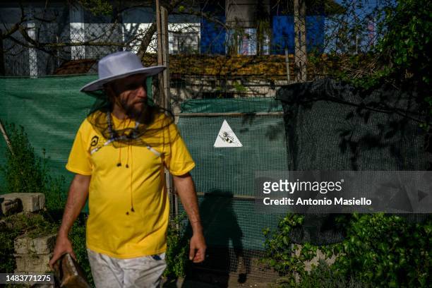 Lorenzo Buratti, beekeeper - breeder, leave the apiary after inspecting the beehives with Italian honey bees , on April 20, 2023 in Terracina, Italy....