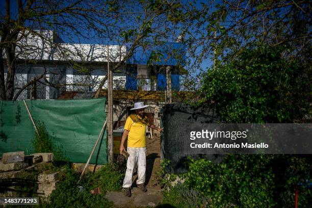 Lorenzo Buratti, beekeeper - breeder, leave the apiary after inspecting the beehives with Italian honey bees , on April 20, 2023 in Terracina, Italy....