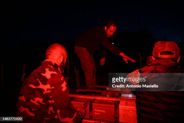 Gianluca, Wiliam and Marco collect on the pick-up the beehives with Italian honey bees , at the bee mating area, on April 19, 2023 in Ponza, Italy. A...