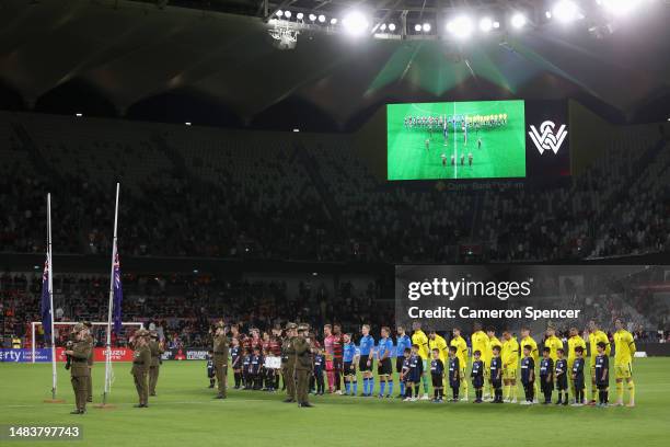 Players line up during an ANZAC ceremony during the round 25 A-League Men's match between Western Sydney Wanderers and Wellington Phoenix at CommBank...