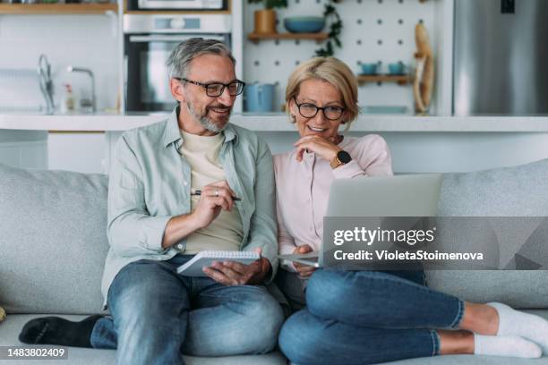 mature couple managing budget and paying bills and taxes. - preencher um formulário imagens e fotografias de stock